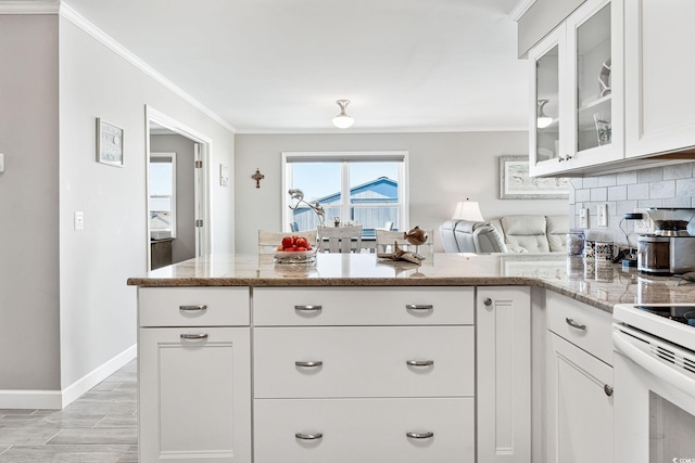 kitchen featuring white cabinets, light wood-type flooring, ornamental molding, decorative backsplash, and light stone countertops