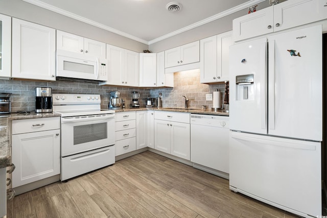 kitchen featuring white appliances, white cabinets, and tasteful backsplash