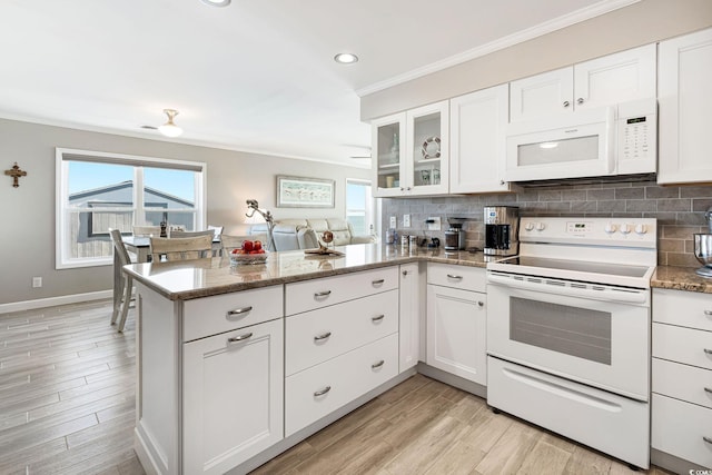 kitchen with white appliances and white cabinetry