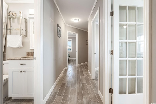 hall featuring light wood-type flooring and crown molding