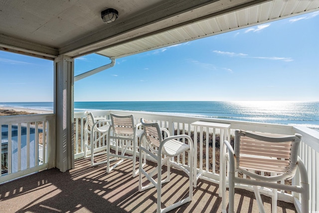 balcony with a beach view and a water view