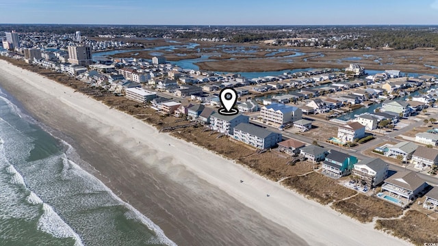 birds eye view of property with a water view and a view of the beach