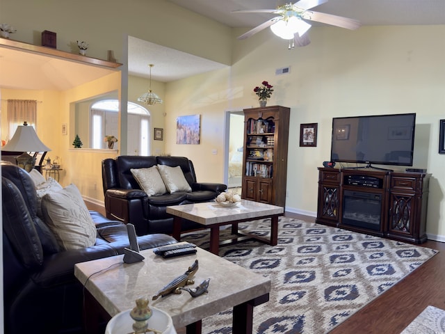 living room featuring hardwood / wood-style flooring, high vaulted ceiling, and ceiling fan