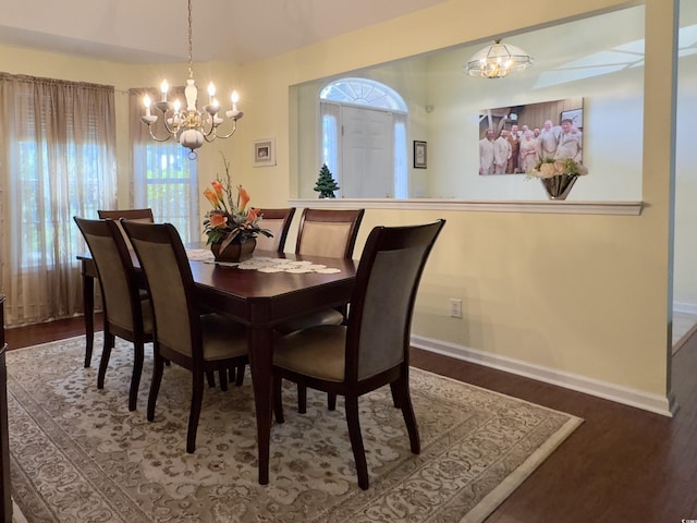 dining room featuring wood-type flooring and an inviting chandelier