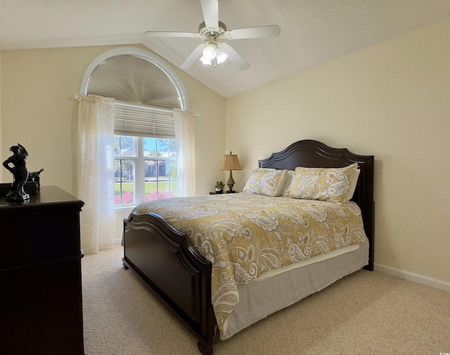 bedroom featuring ceiling fan, light colored carpet, and vaulted ceiling