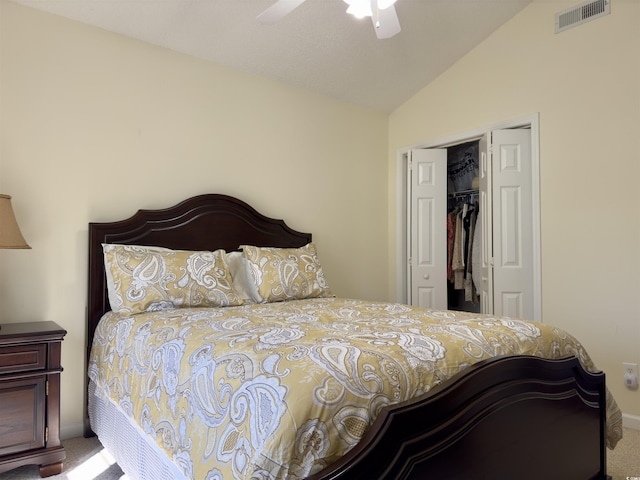 carpeted bedroom featuring a closet, lofted ceiling, and ceiling fan