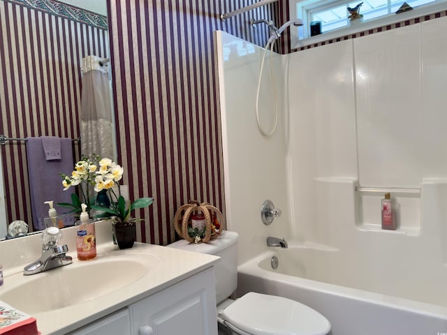 full bathroom featuring toilet, bathing tub / shower combination, and vanity