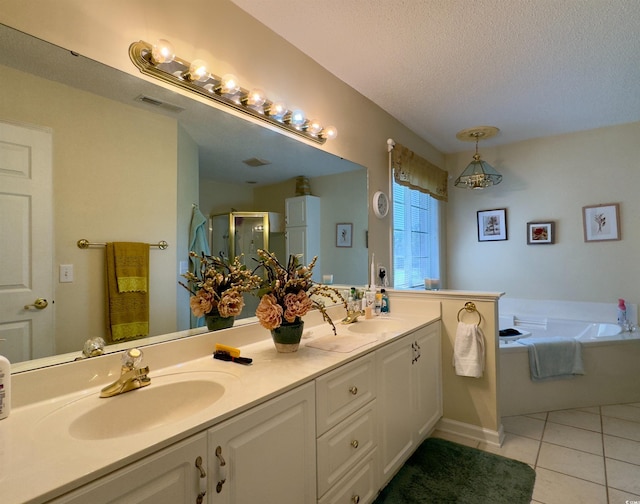 bathroom with vanity, tile patterned flooring, independent shower and bath, and a textured ceiling