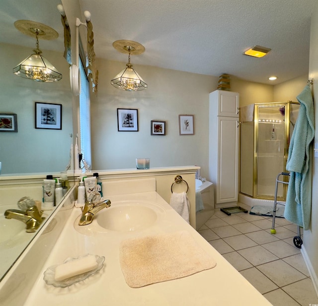 bathroom featuring a textured ceiling, tile patterned floors, vanity, and plus walk in shower