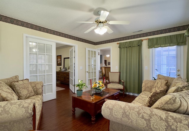 living room with ceiling fan, dark wood-type flooring, and french doors