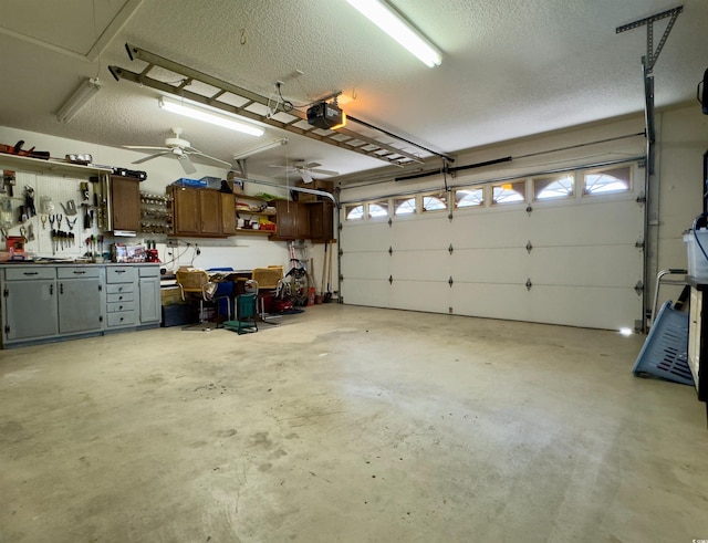 garage featuring ceiling fan, a workshop area, and a garage door opener