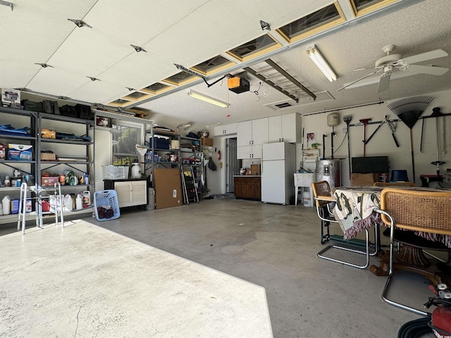 garage featuring white fridge, a garage door opener, and ceiling fan