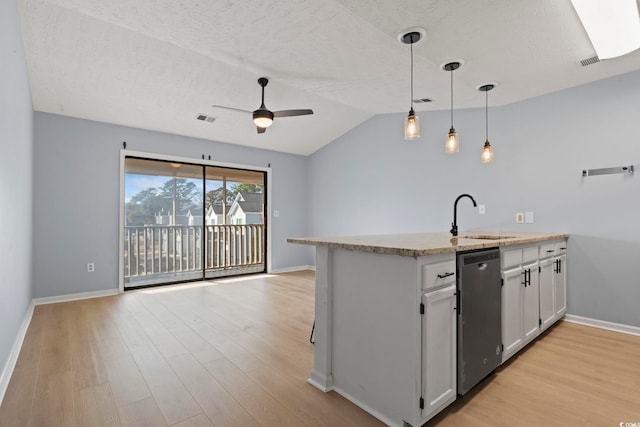 kitchen with sink, dishwasher, white cabinetry, decorative light fixtures, and vaulted ceiling