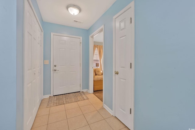 entryway with light tile patterned floors