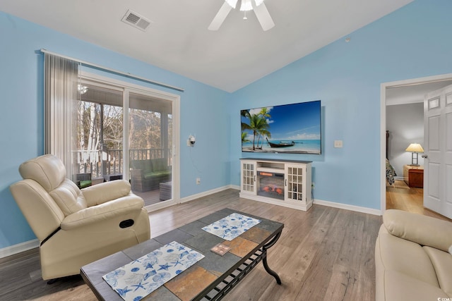 living room with lofted ceiling, wood-type flooring, and ceiling fan