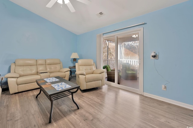 living room featuring lofted ceiling, ceiling fan, and light hardwood / wood-style floors