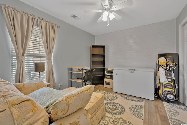 interior space featuring ceiling fan, refrigerator, and light wood-type flooring