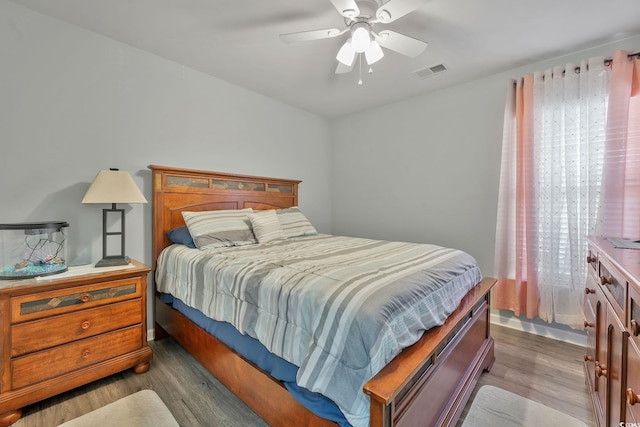 bedroom with wood-type flooring and ceiling fan