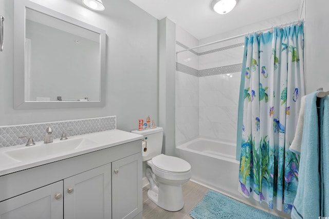 full bathroom featuring toilet, vanity, hardwood / wood-style floors, and shower / bath combo with shower curtain