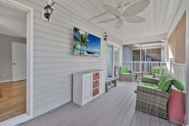 wooden deck with ceiling fan and an outdoor hangout area