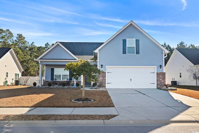 view of front property featuring a garage and central AC unit