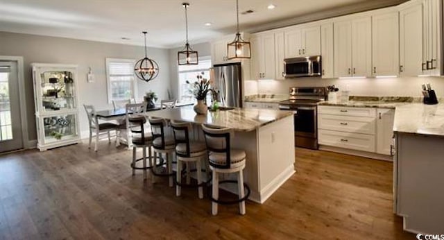 kitchen featuring white cabinetry, stainless steel appliances, and a kitchen island