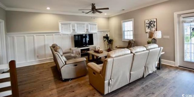 living room with ceiling fan, crown molding, and a healthy amount of sunlight