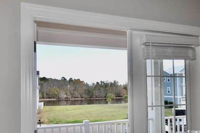 doorway to outside with a water view