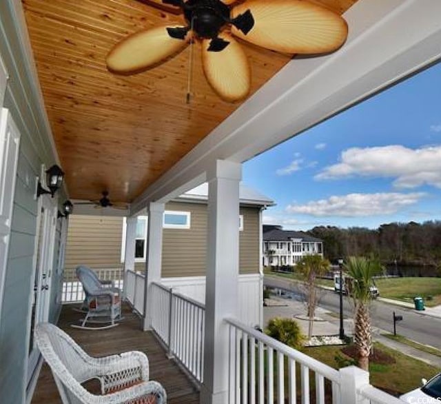 balcony with ceiling fan and a porch