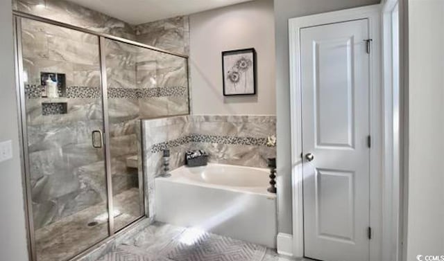 bathroom with separate shower and tub