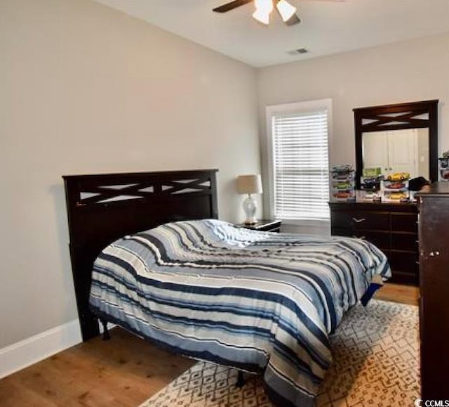 bedroom with ceiling fan and wood-type flooring