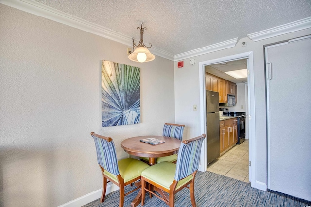 tiled dining space with a textured ceiling and ornamental molding