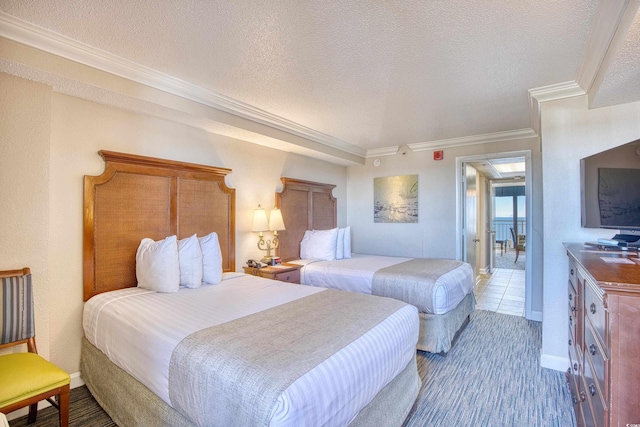 bedroom with a textured ceiling and crown molding