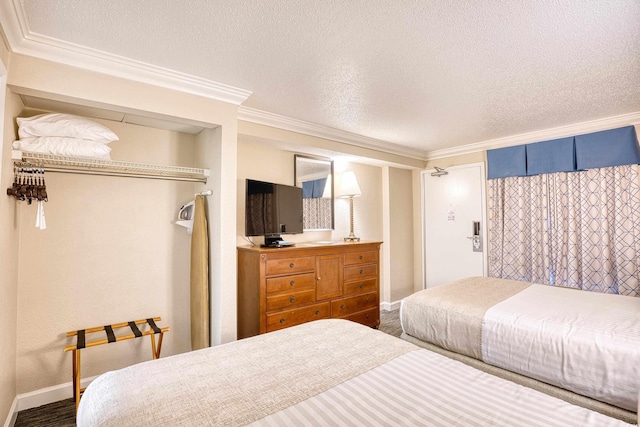 bedroom featuring a textured ceiling, ornamental molding, a closet, and dark hardwood / wood-style floors