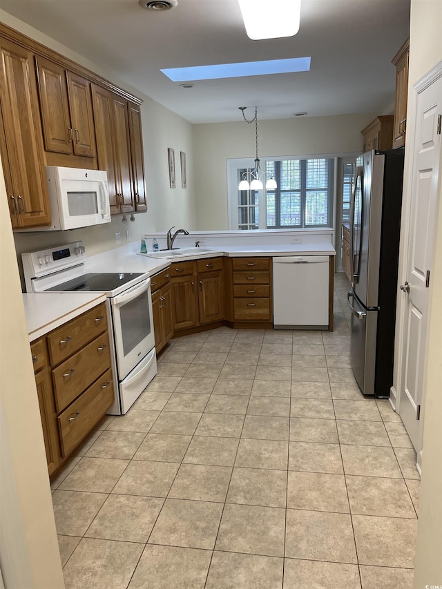 35 Dornoch Dr, Pawleys Island, SC 29585 - kitchen featuring a sink, light countertops, a peninsula, a notable chandelier, and white appliances