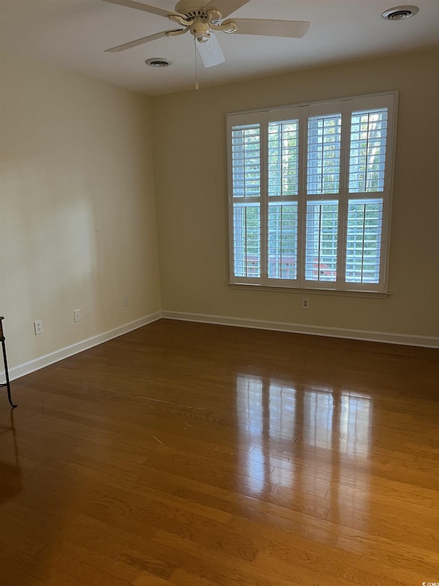 unfurnished room with ceiling fan and wood-type flooring