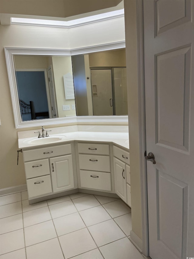 bathroom with vanity, a shower with door, and tile patterned flooring