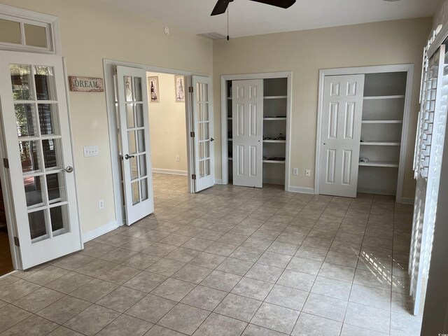 35 Dornoch Dr, Pawleys Island, SC 29585 - unfurnished bedroom with two closets, ceiling fan, baseboards, and french doors