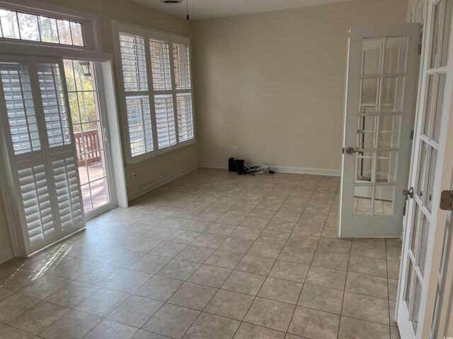 35 Dornoch Dr, Pawleys Island, SC 29585 - empty room featuring light tile patterned floors, baseboards, and french doors