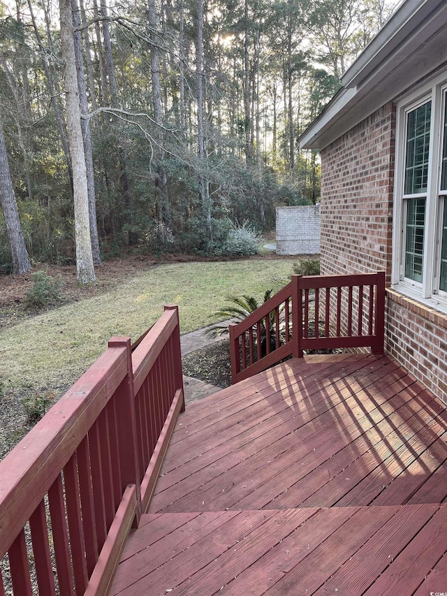 wooden deck featuring a yard