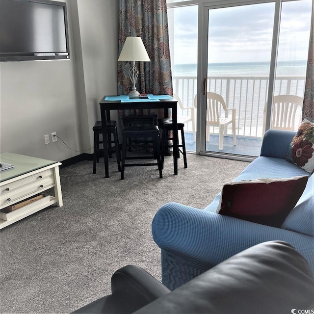 living room with carpet flooring and a water view