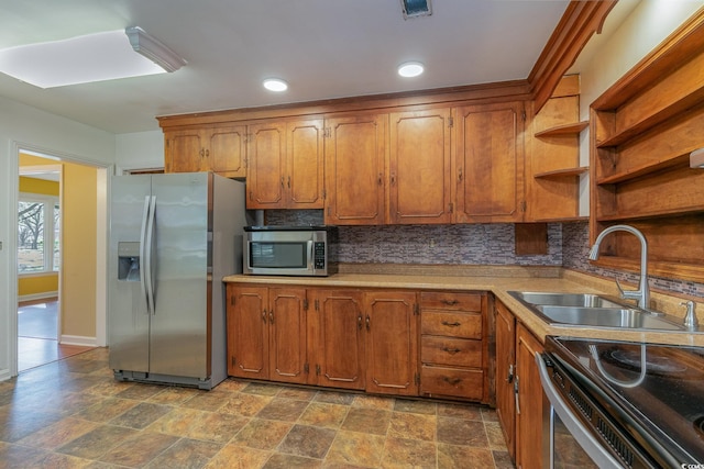 kitchen featuring stainless steel appliances, sink, and decorative backsplash