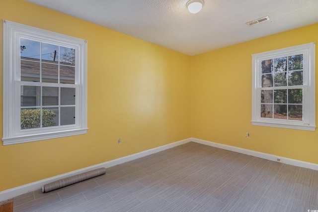 spare room featuring a textured ceiling