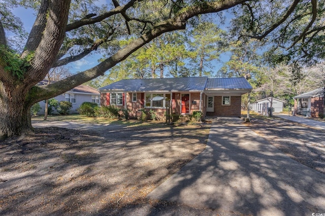 ranch-style house with an outbuilding, a garage, and covered porch