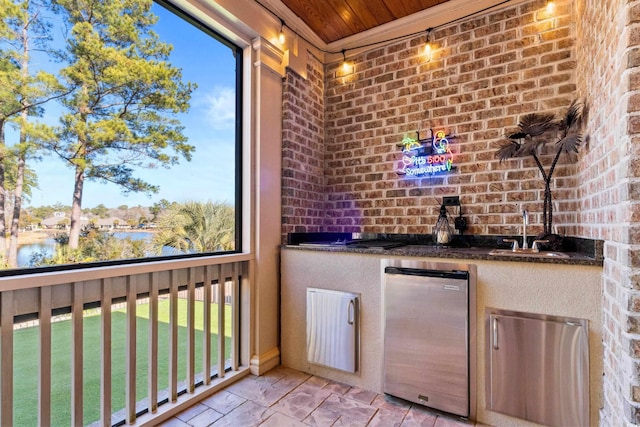 interior space featuring brick wall, wood ceiling, a water view, and sink