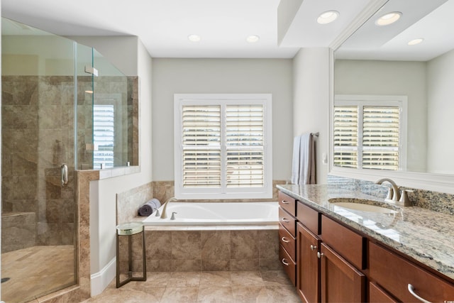 bathroom featuring vanity and shower with separate bathtub