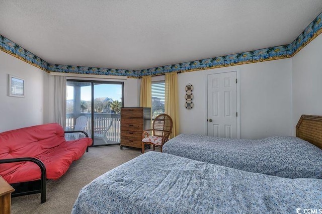 bedroom featuring access to exterior, a textured ceiling, and light colored carpet