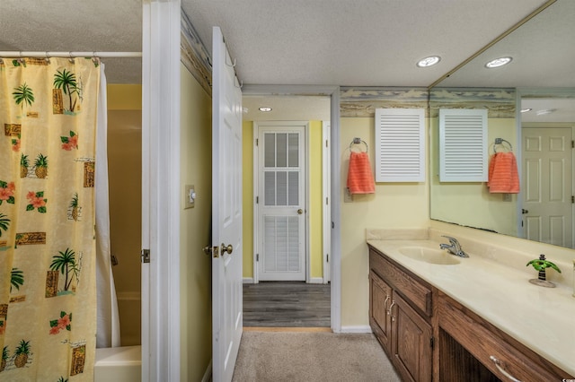 bathroom featuring a textured ceiling and vanity