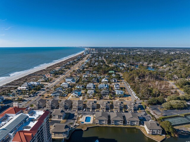 birds eye view of property featuring a water view and a beach view