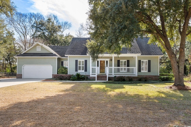 view of front of house featuring a garage, covered porch, and a front lawn